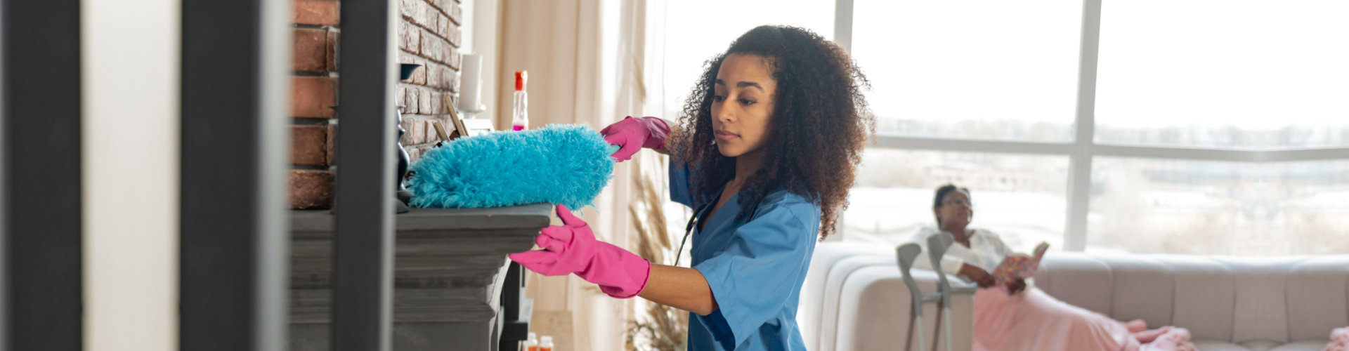 a home health aide cleaning the house of the patient