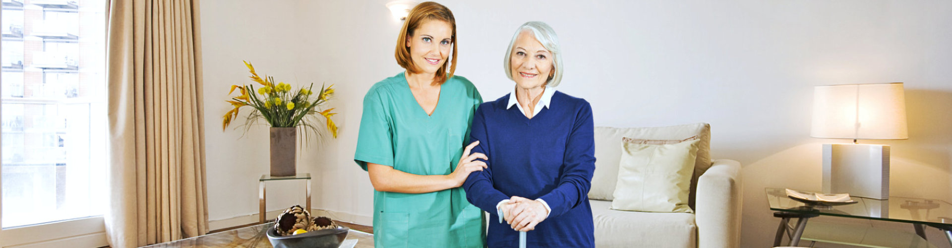 caregiver taking care of an elderly, posing for a picture at home